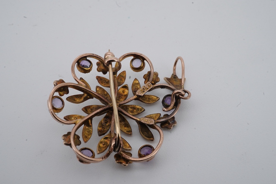 An Edwardian seed pearl and amethyst pendant, early 20th century, of floral design, set with seed pearls and circular-cut amethysts, mounted in gold, length 4cm including bail, brooch fitting, stamped 9ct and H&GB, Condi